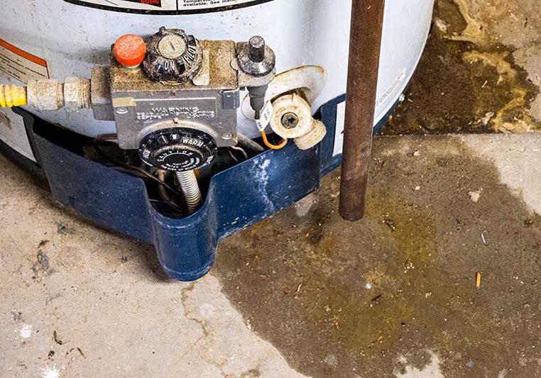 Close up of an old leaking water heater that needs replaced